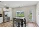 Bright dining area features a modern table with seating for four, and a view of the outdoors through the window at 1181 Chastain Dr, Sugar Hill, GA 30518