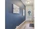 Modern entryway with beautiful hardwood flooring, blue accent wall, and elegant decor at 1181 Chastain Dr, Sugar Hill, GA 30518