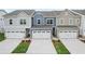 Charming townhomes showcase well-kept lawns and attached garages, offering a blend of comfort and contemporary living at 1181 Chastain Dr, Sugar Hill, GA 30518