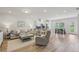 Spacious and bright open-concept living room features hardwood floors and cozy furniture at 1181 Chastain Dr, Sugar Hill, GA 30518