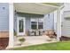 Charming patio with seating area, potted plants, and landscaped surroundings at 1181 Chastain Dr, Sugar Hill, GA 30518