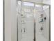 Bright shower with glass doors and built-in shelving for toiletries at 1181 Chastain Dr, Sugar Hill, GA 30518
