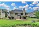 View of the backyard with a well-maintained lawn, iron fence, and mature landscaping at 1868 Birch Briar Bnd, Lawrenceville, GA 30043