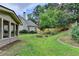 Lush backyard featuring an immaculate lawn with mature landscaping and privacy fence at 1868 Birch Briar Bnd, Lawrenceville, GA 30043