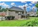 Expansive backyard featuring a screened-in porch and lush greenery, perfect for outdoor living at 1868 Birch Briar Bnd, Lawrenceville, GA 30043