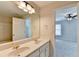 Bright bathroom featuring double sinks, neutral walls, and a view to the adjacent bedroom at 1868 Birch Briar Bnd, Lawrenceville, GA 30043