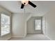 Cozy bedroom features a ceiling fan, carpet, and windows providing plenty of natural light at 1868 Birch Briar Bnd, Lawrenceville, GA 30043
