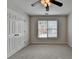 Bedroom with neutral walls, double closets, and a large window at 1868 Birch Briar Bnd, Lawrenceville, GA 30043