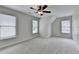 This airy bedroom has carpet and a ceiling fan, along with multiple windows for lots of natural light at 1868 Birch Briar Bnd, Lawrenceville, GA 30043