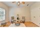 Bright bedroom with hardwood floors, a ceiling fan, and a cozy seating area, perfect for relaxation at 1868 Birch Briar Bnd, Lawrenceville, GA 30043