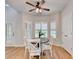 Charming breakfast nook with a round table, white chairs, and natural light streaming through shuttered windows at 1868 Birch Briar Bnd, Lawrenceville, GA 30043