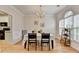 Bright dining room showcasing crown molding, chandelier, and connection to the kitchen at 1868 Birch Briar Bnd, Lawrenceville, GA 30043