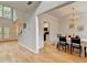 Inviting dining room features hardwood floors, elegant chandelier, and views into the kitchen at 1868 Birch Briar Bnd, Lawrenceville, GA 30043