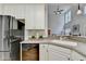 Bright kitchen featuring white cabinets, stainless steel refrigerator, and an open layout to the living area at 1868 Birch Briar Bnd, Lawrenceville, GA 30043