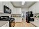Well-appointed kitchen with white cabinets, stainless steel appliances, and ample counter space for meal preparation at 1868 Birch Briar Bnd, Lawrenceville, GA 30043