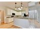 Open kitchen with a breakfast bar, white cabinetry, modern appliances, and seamless access to the living room at 1868 Birch Briar Bnd, Lawrenceville, GA 30043