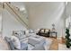 Cozy living room with hardwood floors, large windows, and a staircase leading to the upper level at 1868 Birch Briar Bnd, Lawrenceville, GA 30043