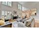 Open-concept living room with hardwood floors, fireplace, and easy access to the breakfast area and kitchen at 1868 Birch Briar Bnd, Lawrenceville, GA 30043