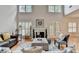 Bright living room with fireplace, hardwood floors, and lots of natural light from large windows at 1868 Birch Briar Bnd, Lawrenceville, GA 30043