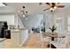 Inviting living area with an open kitchen, wood floors, fireplace, and ample natural light, ideal for gatherings at 1868 Birch Briar Bnd, Lawrenceville, GA 30043