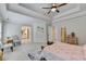 Large main bedroom featuring a tray ceiling and a view into the attached bathroom at 1868 Birch Briar Bnd, Lawrenceville, GA 30043