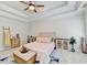 Sun-filled main bedroom with a ceiling fan, a tray ceiling and an abundance of space and light at 1868 Birch Briar Bnd, Lawrenceville, GA 30043