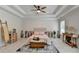 Inviting main bedroom with a tray ceiling, a ceiling fan and neutral decor throughout at 1868 Birch Briar Bnd, Lawrenceville, GA 30043