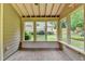 Relaxing sunroom featuring brick flooring and multiple windows overlooking the peaceful backyard at 1868 Birch Briar Bnd, Lawrenceville, GA 30043