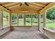 Enclosed sunroom with brick floors, neutral trim, and serene views of the backyard at 1868 Birch Briar Bnd, Lawrenceville, GA 30043
