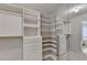 Customized walk-in closet featuring built-in shelving and hanging racks at 1868 Birch Briar Bnd, Lawrenceville, GA 30043