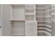 Customized walk-in closet with built-in shelving, hanging racks, and drawers at 1868 Birch Briar Bnd, Lawrenceville, GA 30043