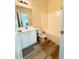 Bright bathroom featuring wood-look floors, a white vanity, and a toilet with a shower/tub combo at 4460 Greycliff Pte, Douglasville, GA 30135