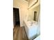Bright bathroom features a double sink vanity with large mirror and access to walk-in closet at 4460 Greycliff Pte, Douglasville, GA 30135