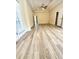 Large bedroom with tray ceiling and wood-look flooring at 4460 Greycliff Pte, Douglasville, GA 30135