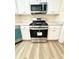 Modern kitchen featuring stainless steel appliances, white cabinets, and new vinyl flooring at 4460 Greycliff Pte, Douglasville, GA 30135
