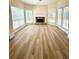 Spacious living room features a fireplace, large windows, and beautiful flooring at 4460 Greycliff Pte, Douglasville, GA 30135