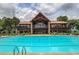 Community clubhouse overlooks an outdoor pool with ample seating and recreational opportunities at 4460 Greycliff Pte, Douglasville, GA 30135