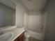 Bathroom features include a shower and tub combination, a wood vanity with white sink, and tile floors at 6361 Redan Sq, Lithonia, GA 30058