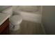 Bathroom features include a shower and tub combination, a white toilet, and gray vinyl flooring at 6361 Redan Sq, Lithonia, GA 30058