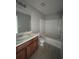 Bathroom features include a shower and tub combination, a dark wood vanity, white sink, and tile floors at 6361 Redan Sq, Lithonia, GA 30058