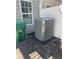 Exterior showing the home's air conditioning system, a green garbage receptacle, and a portion of the home at 6361 Redan Sq, Lithonia, GA 30058