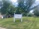 View of Redan Square townhome community signage and common green spaces at 6361 Redan Sq, Lithonia, GA 30058