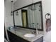 Bathroom features a granite countertop, large mirror, and updated fixtures and shower at 1310 Larkview Sw Dr, Lilburn, GA 30047