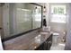 Bathroom features a granite countertop, large mirror, and updated fixtures and shower at 1310 Larkview Sw Dr, Lilburn, GA 30047