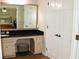 Primary bathroom featuring a vanity with a dark countertop, cream cabinets, and dual doors to the bedroom at 1310 Larkview Sw Dr, Lilburn, GA 30047