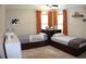 A ' bedroom is brightened with orange curtains and boasts two beds, each with built-in drawer storage at 1310 Larkview Sw Dr, Lilburn, GA 30047