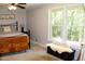 This bedroom features a window overlooking a green landscape, and a Mr. & Mrs. pillow on a wooden chest at 1310 Larkview Sw Dr, Lilburn, GA 30047