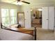Bedroom with a large window, wooden-framed mirror, and double doors leading to the Primary bathroom at 1310 Larkview Sw Dr, Lilburn, GA 30047