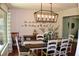Open dining area featuring a long wood table with decorative centerpiece and a geometric light fixture at 1310 Larkview Sw Dr, Lilburn, GA 30047