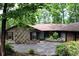 Well-maintained exterior of a single-story home with a brick facade, dark shutters, and a landscaped circular driveway at 1310 Larkview Sw Dr, Lilburn, GA 30047